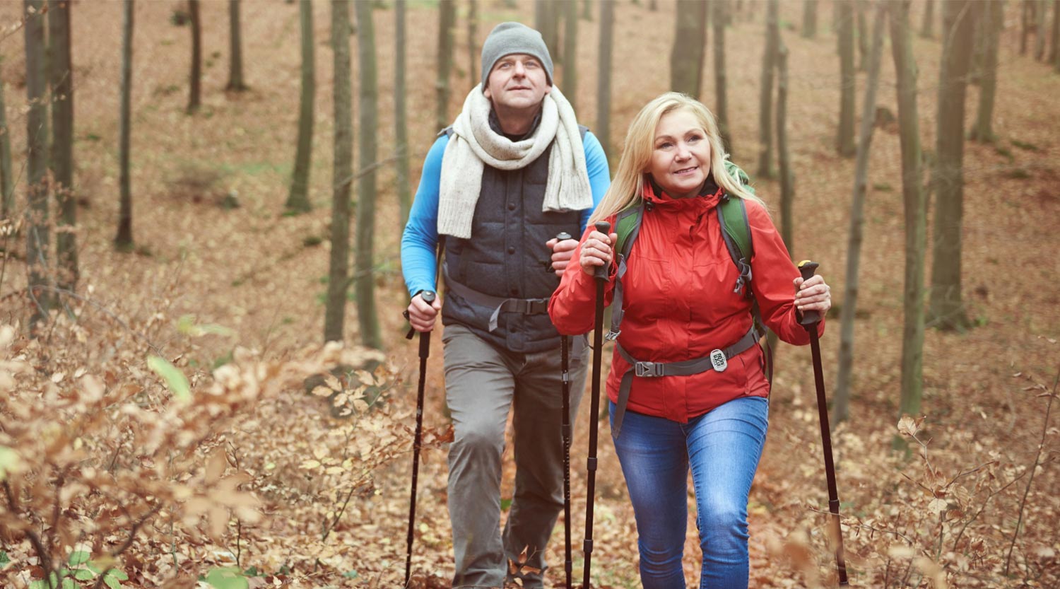 Adult with arthritis walking outdoors using Nordic poles